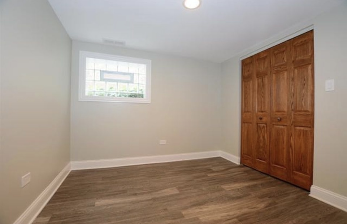 Undisclosed Address Chicago, IL 60628 - Photo 25 of 27 an empty room with wooden floor and windows