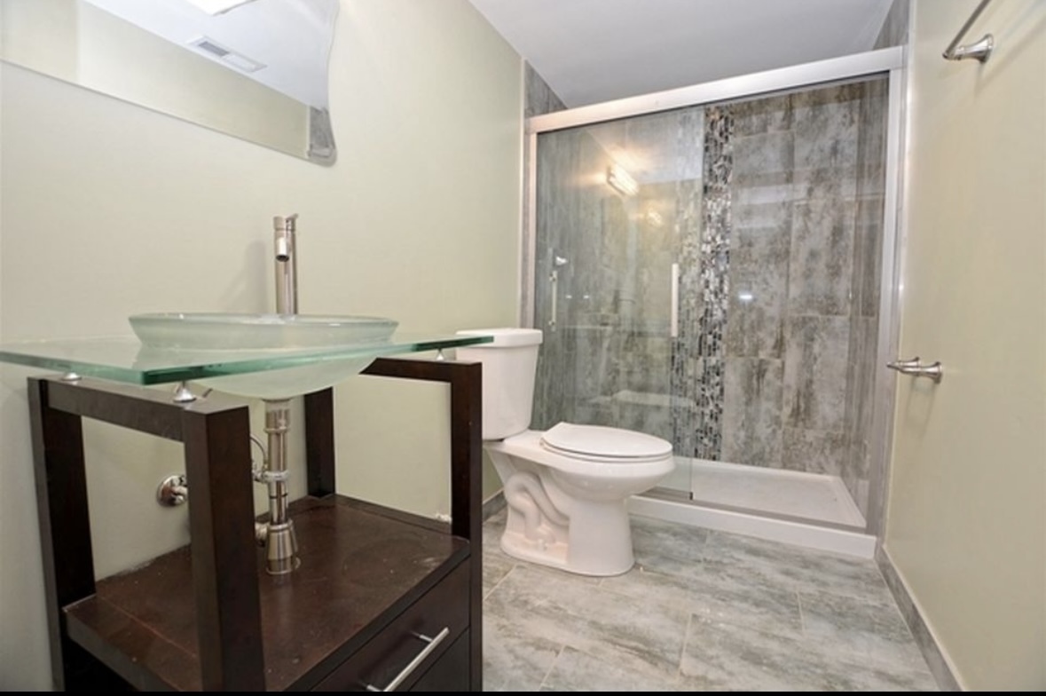 Undisclosed Address Chicago, IL 60628 - Photo 26 of 27 a bathroom with a sink a toilet and shower