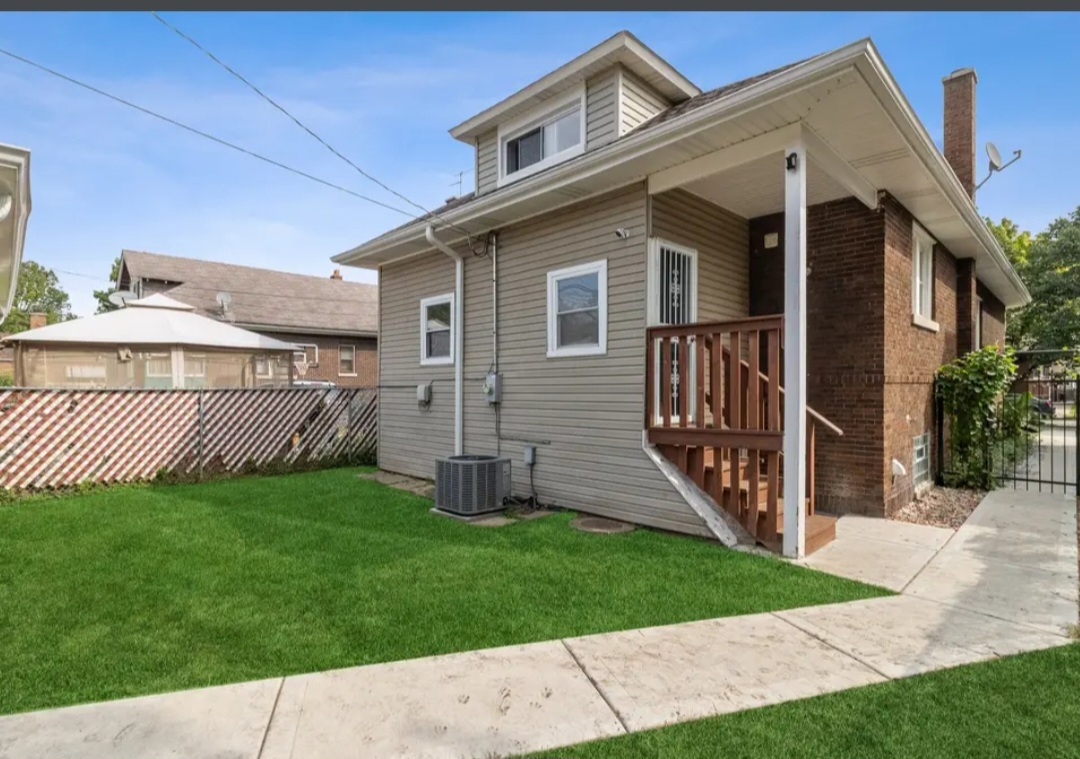 Undisclosed Address Chicago, IL 60628 - Photo 4 of 27 a view of a house with a yard