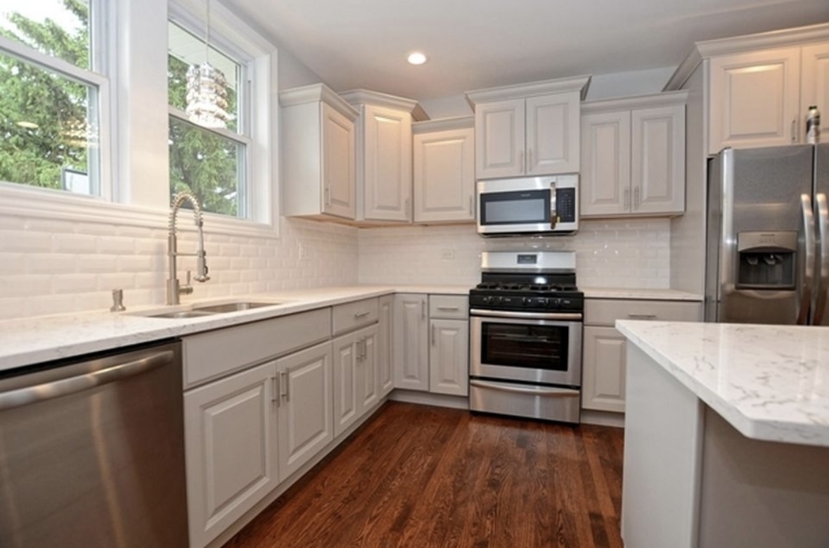Undisclosed Address Chicago, IL 60628 - Photo 9 of 27 a kitchen with a sink stove and microwave