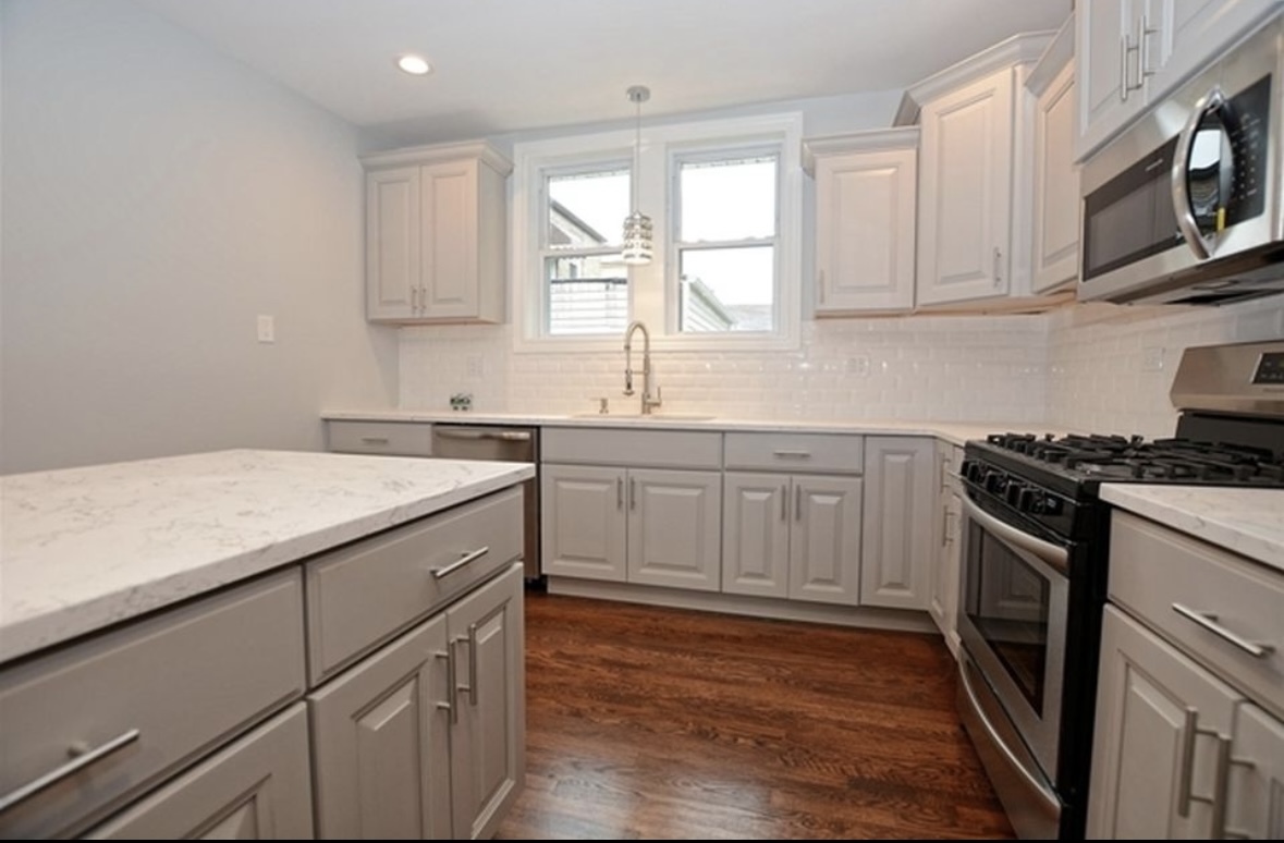 Undisclosed Address Chicago, IL 60628 - Photo 10 of 27 a kitchen with a sink stove and cabinets