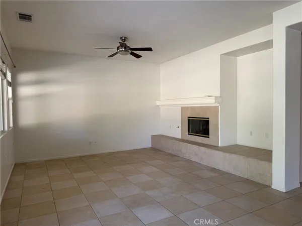 a view of empty room with a fireplace
