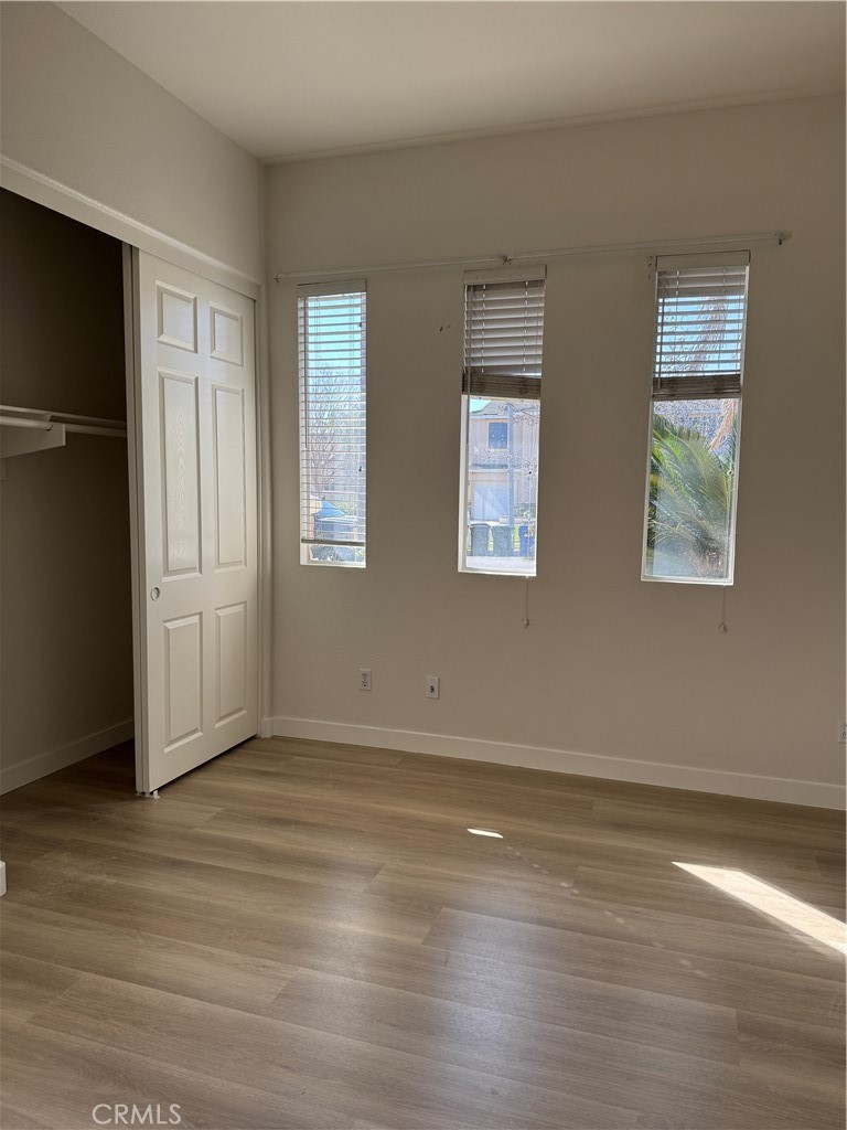 13628 Jeremy Court Rancho Cucamonga, CA 91739 - Photo 16 of 29 a view of an empty room with wooden floor and a window