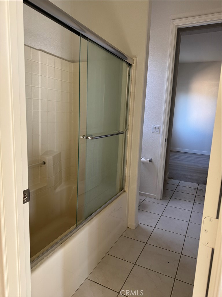 13628 Jeremy Court Rancho Cucamonga, CA 91739 - Photo 18 of 29 a bathroom with a glass shower door