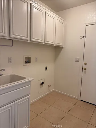 a utility room with cabinets washer and dryer