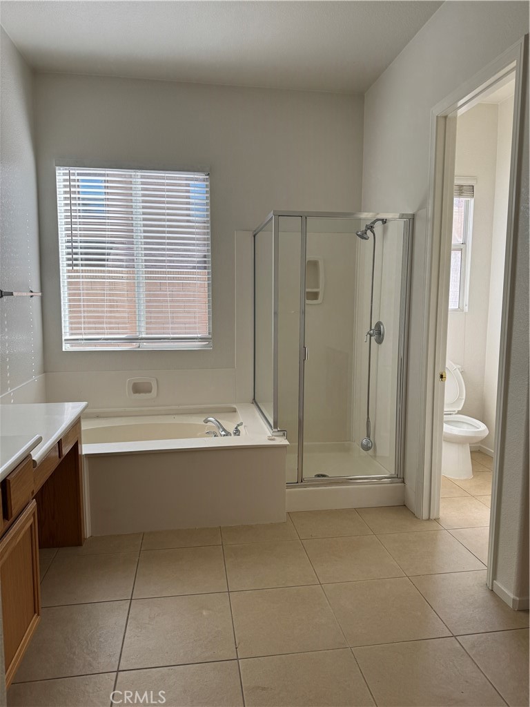 13628 Jeremy Court Rancho Cucamonga, CA 91739 - Photo 25 of 29 a bathroom with a tub shower and toilet