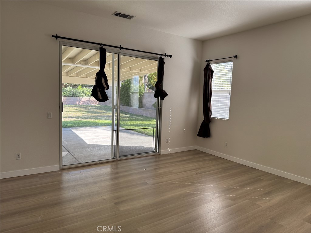 13628 Jeremy Court Rancho Cucamonga, CA 91739 - Photo 26 of 29 an empty room with wooden floor and windows