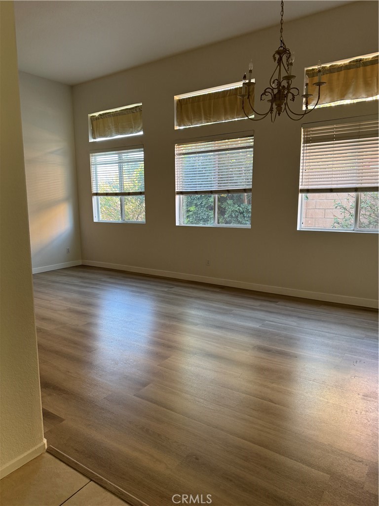 13628 Jeremy Court Rancho Cucamonga, CA 91739 - Photo 4 of 29 wooden floor in an empty room with a window