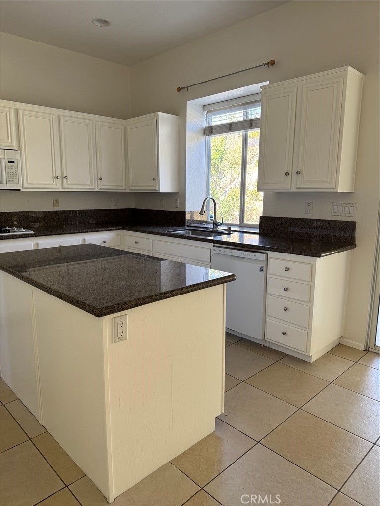 13628 Jeremy Court Rancho Cucamonga, CA 91739 - Photo 10 of 29 a kitchen with granite countertop white cabinets sink and white appliances