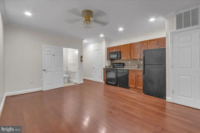 a kitchen with stainless steel appliances a refrigerator and a stove top oven