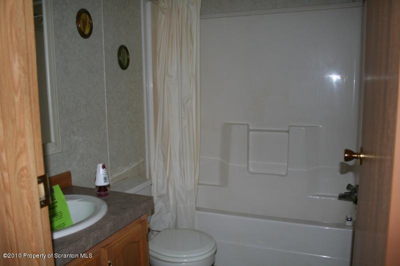 351 R Casterline Road Harveys Lake, PA 18618 - Photo 11 of 13 a bathroom with a granite countertop bathtub shower