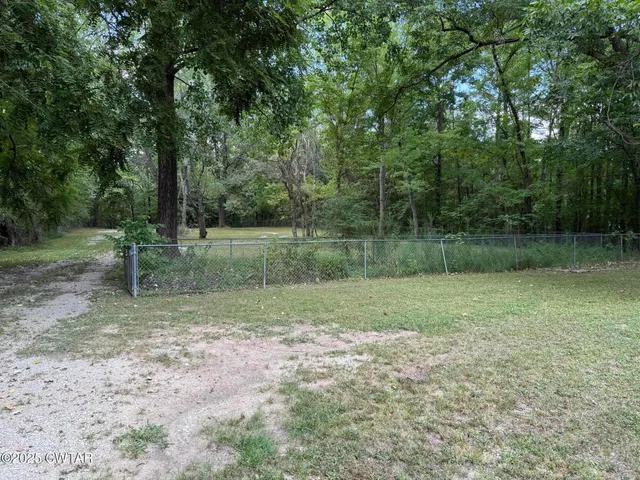 a view of outdoor space with deck and yard