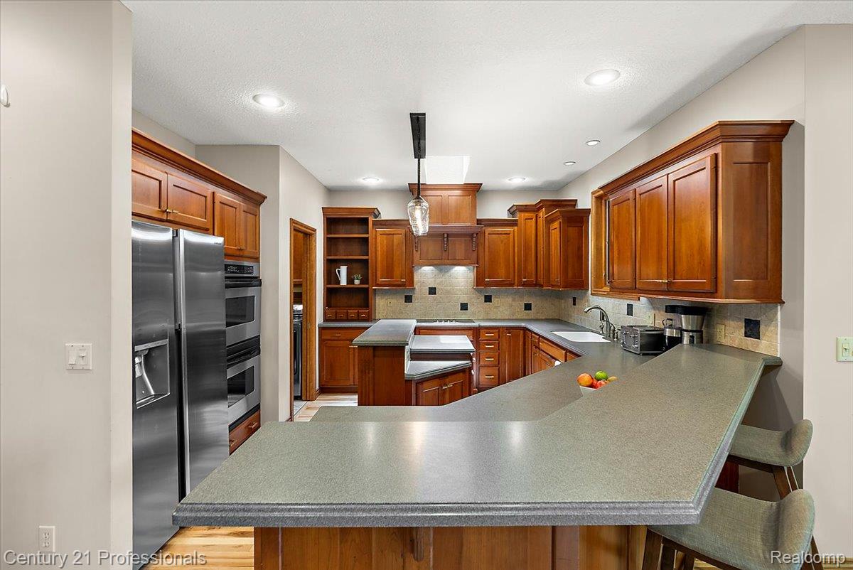 9867 Rainbow Ridge Drive Schoolcraft, MI 49087 - Photo 22 of 82 Kitchen featuring abundant wood cabinetry, recessed lighting, and stainless steel appliances