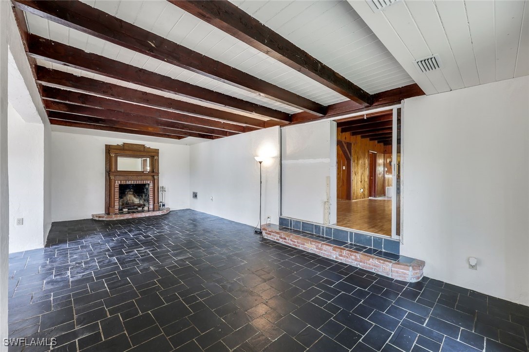 18191 Slater Road North Fort Myers, FL 33917 - Photo 12 of 34 a view of a room with wooden floor and a ceiling fan