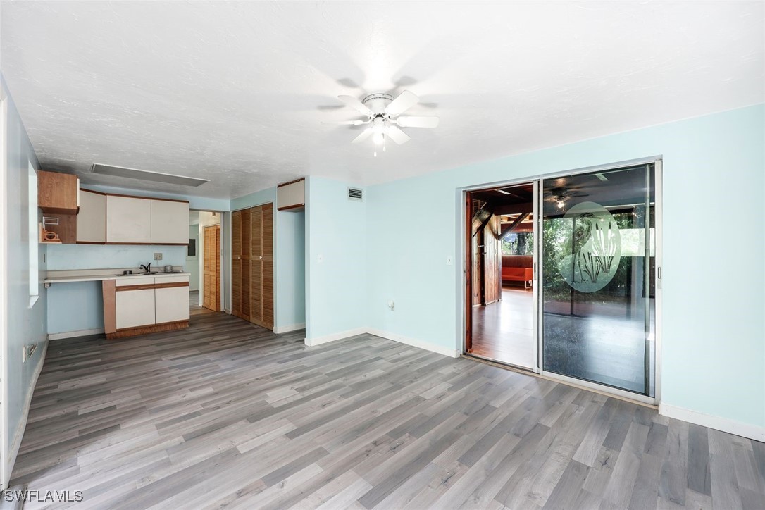 18191 Slater Road North Fort Myers, FL 33917 - Photo 16 of 34 a view of a kitchen with wooden floor and a ceiling fan