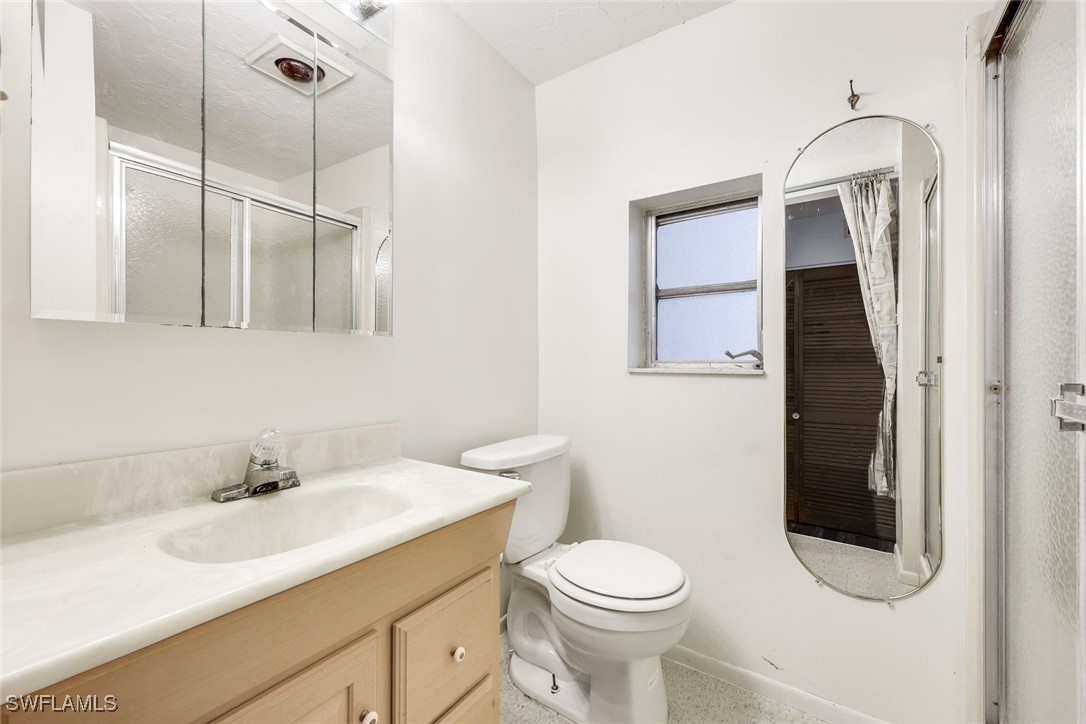 18191 Slater Road North Fort Myers, FL 33917 - Photo 18 of 34 a bathroom with a sink a toilet and a mirror