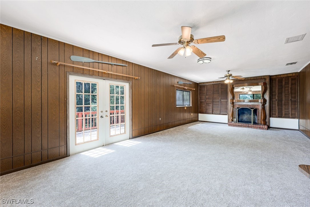 18191 Slater Road North Fort Myers, FL 33917 - Photo 19 of 34 a view of empty room with fireplace and fan
