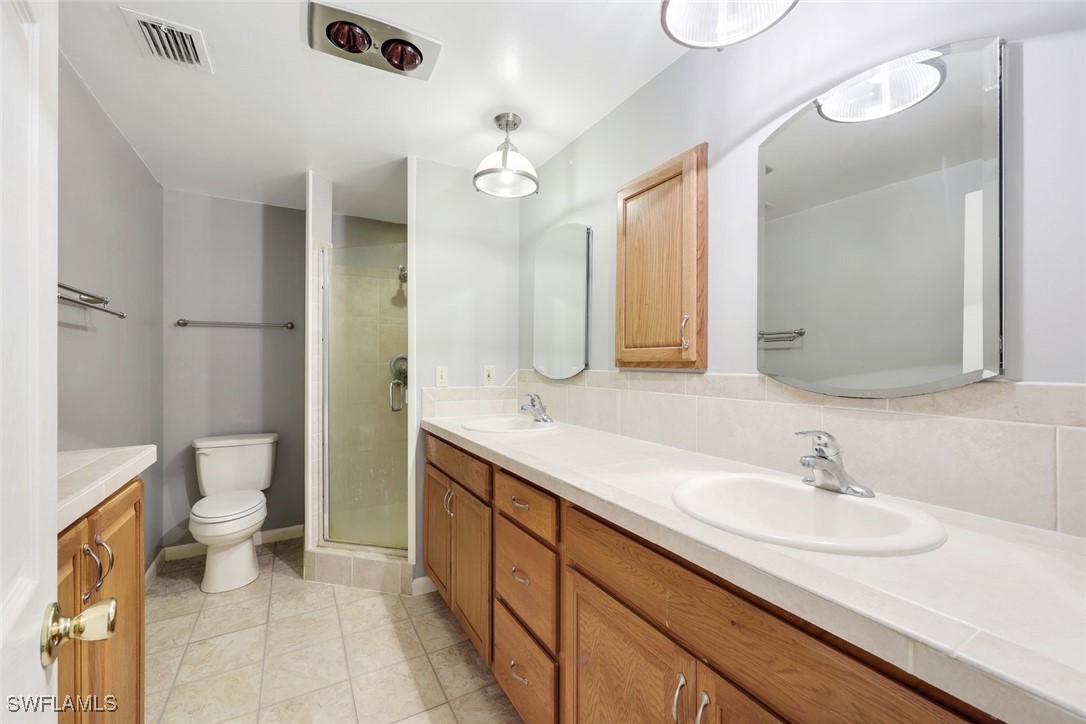 18191 Slater Road North Fort Myers, FL 33917 - Photo 28 of 34 a bathroom with a sink a toilet and a mirror