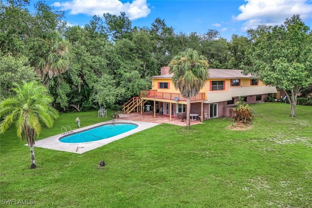 18191 Slater Road North Fort Myers, FL 33917 - Photo 4 of 34 a view of a house with a big yard and large trees