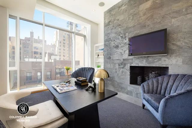 a living room with fireplace furniture and a flat screen tv