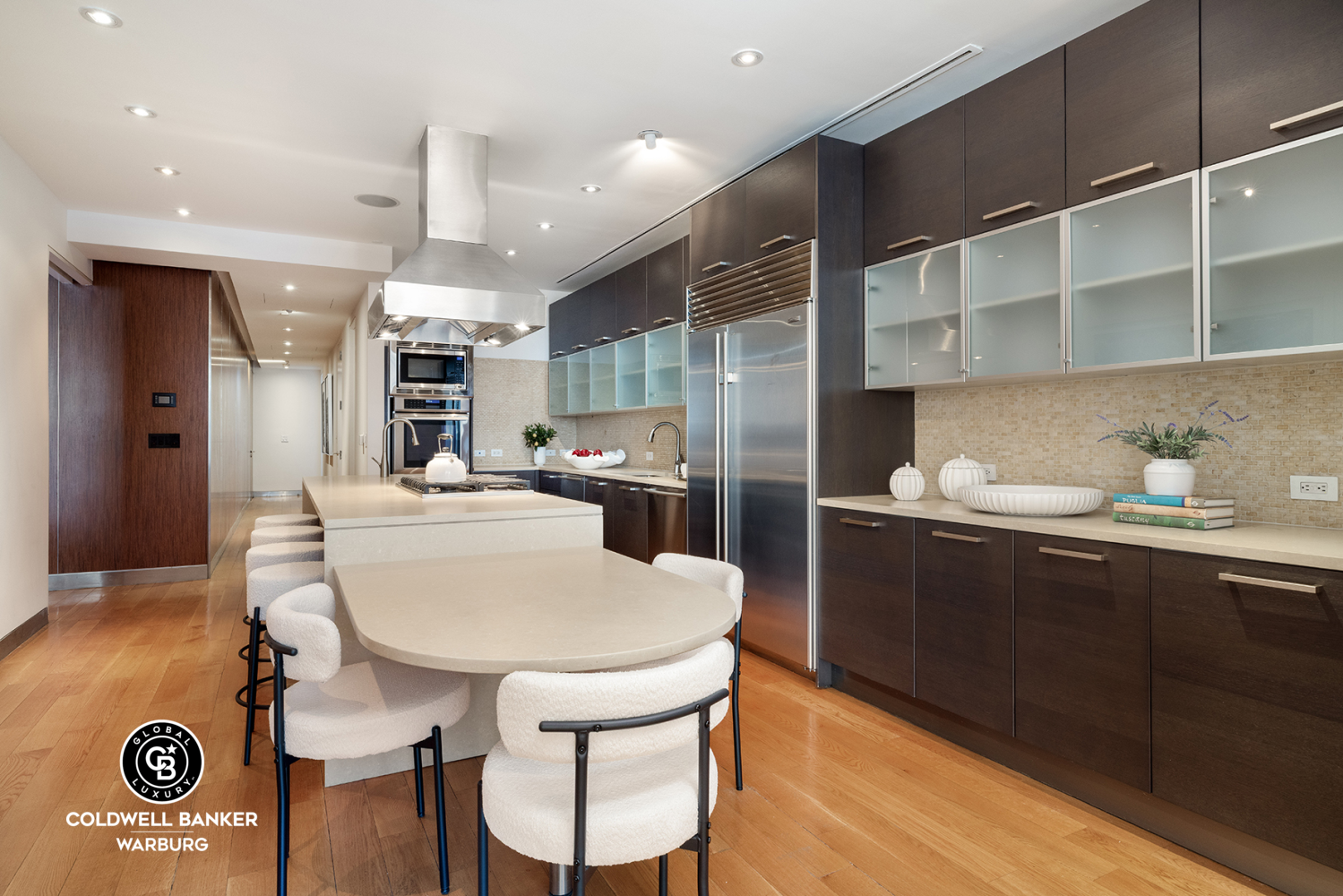 157 East 84th Street, Unit PH Manhattan, NY 10028 - Photo 4 of 17 a kitchen with stainless steel appliances granite countertop a sink a stove a refrigerator and cabinets