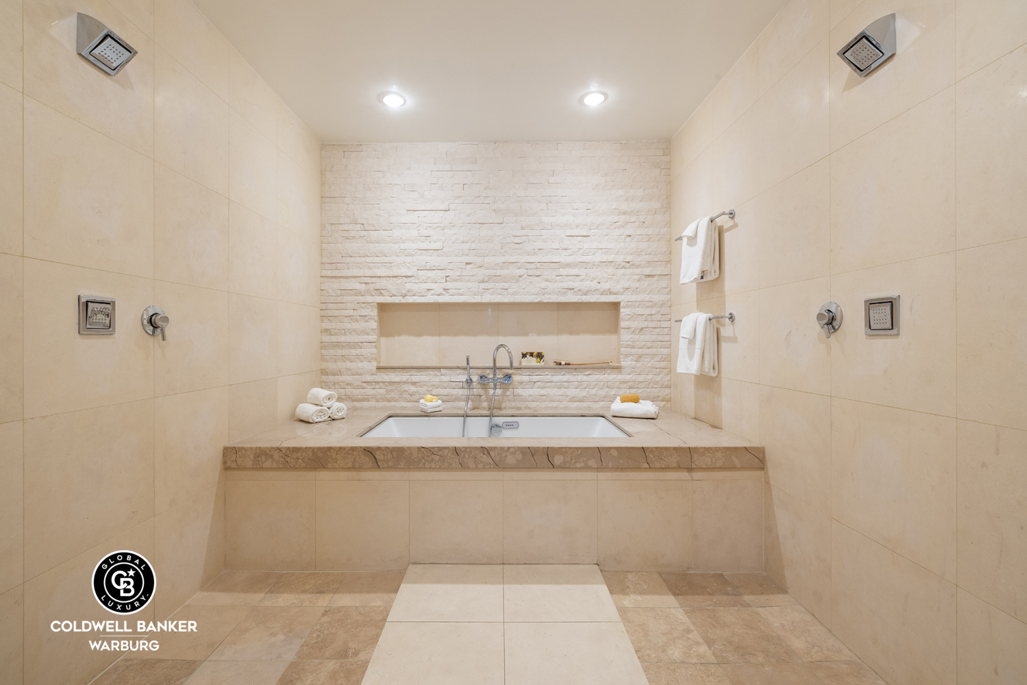 157 East 84th Street, Unit PH Manhattan, NY 10028 - Photo 7 of 17 a bathroom with a sink a mirror and a shower