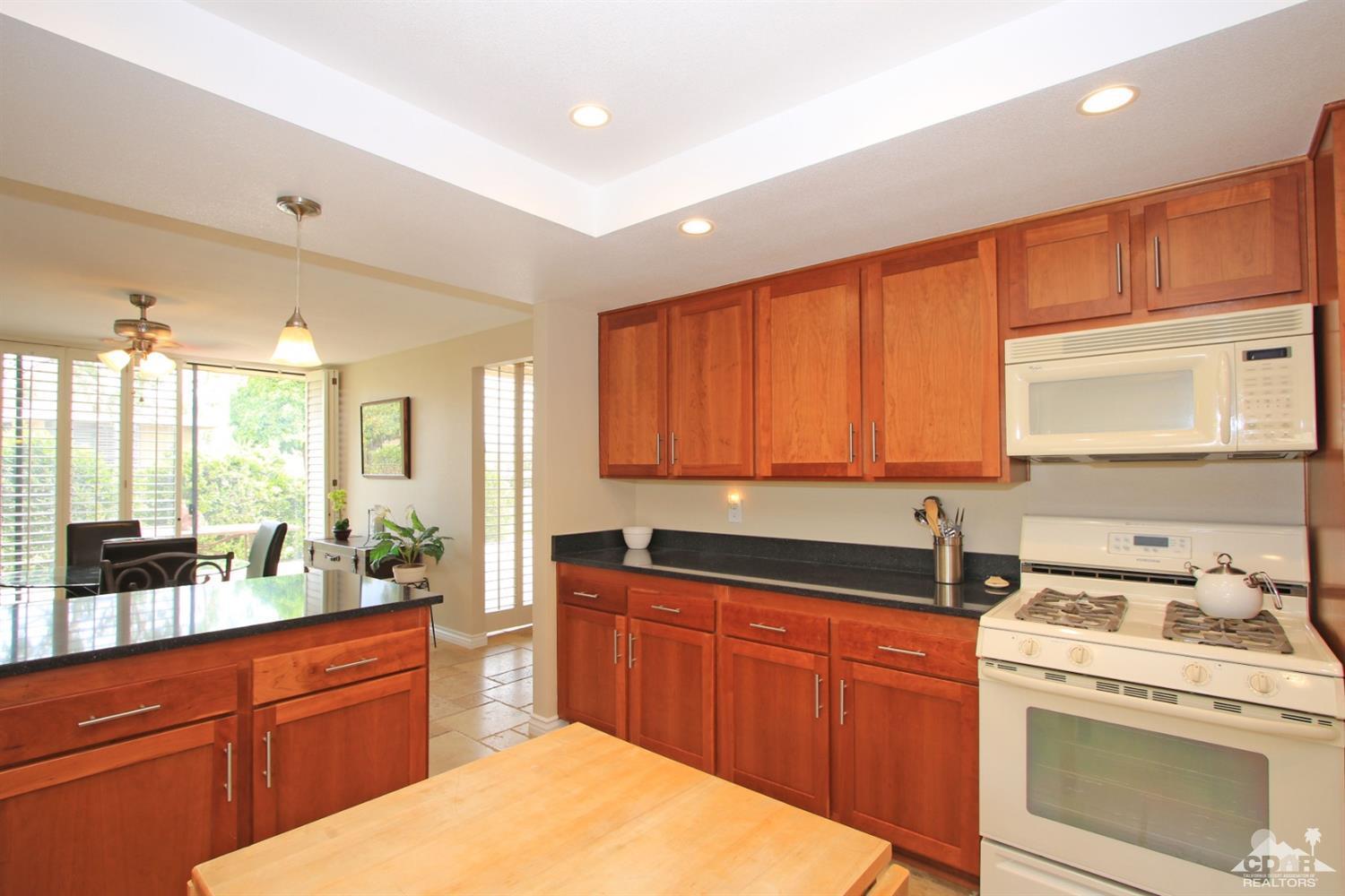 72350 Rodeo Way Rancho Mirage, CA 92270 - Photo 11 of 44 a kitchen with a sink stove and cabinets