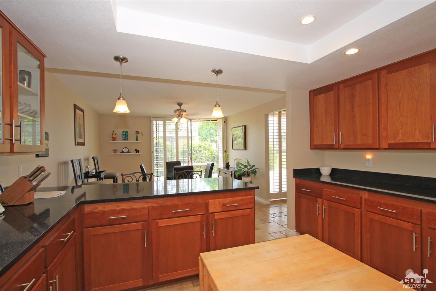 72350 Rodeo Way Rancho Mirage, CA 92270 - Photo 12 of 44 a large kitchen with stainless steel appliances granite countertop wooden cabinets a sink and dishwasher