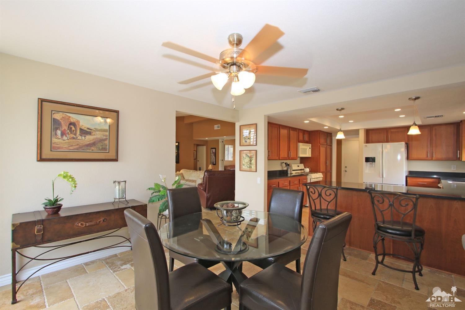 72350 Rodeo Way Rancho Mirage, CA 92270 - Photo 14 of 44 a view of a dining room with furniture and a chandelier