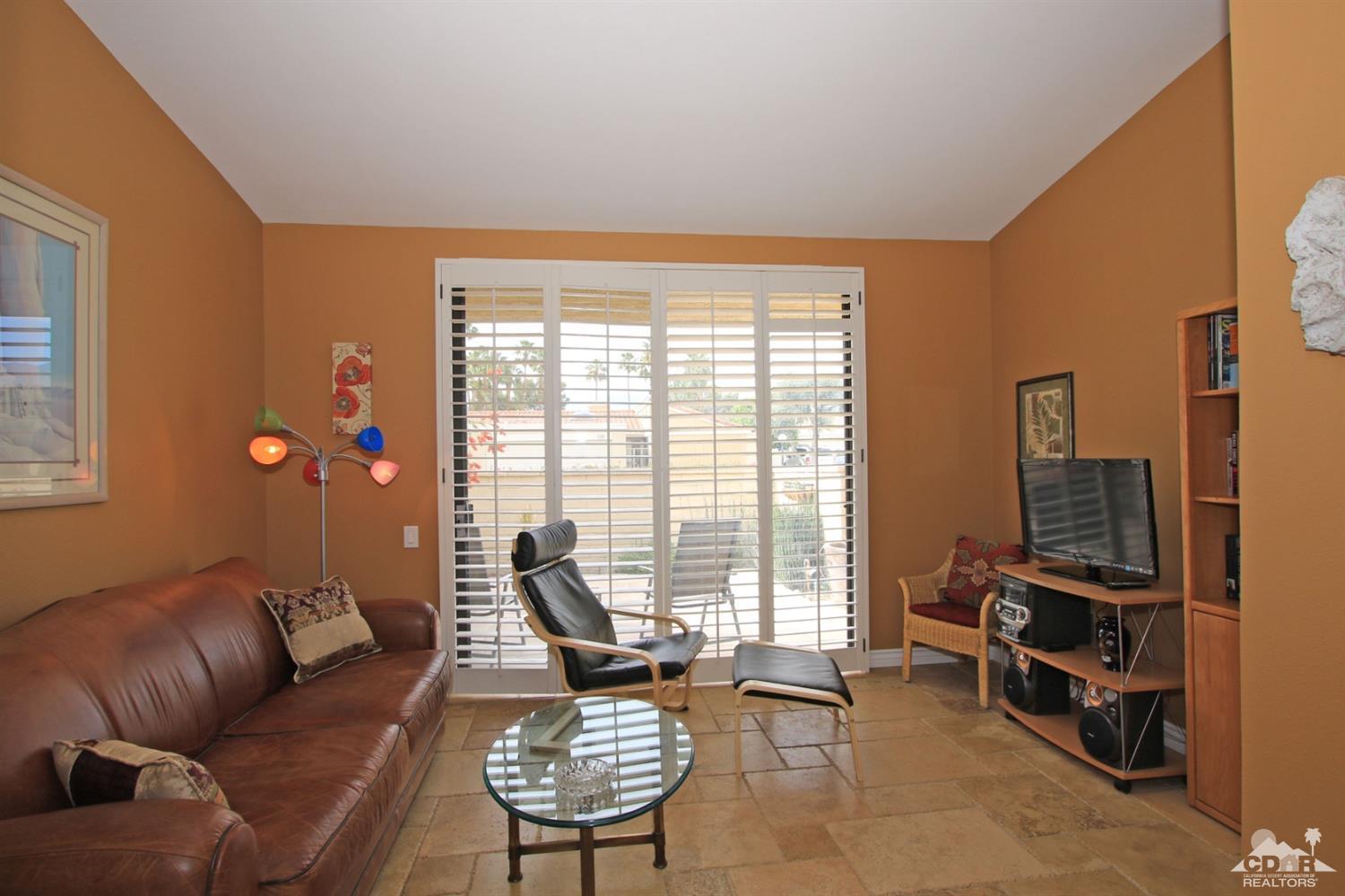 72350 Rodeo Way Rancho Mirage, CA 92270 - Photo 16 of 44 a living room with furniture and a floor to ceiling window