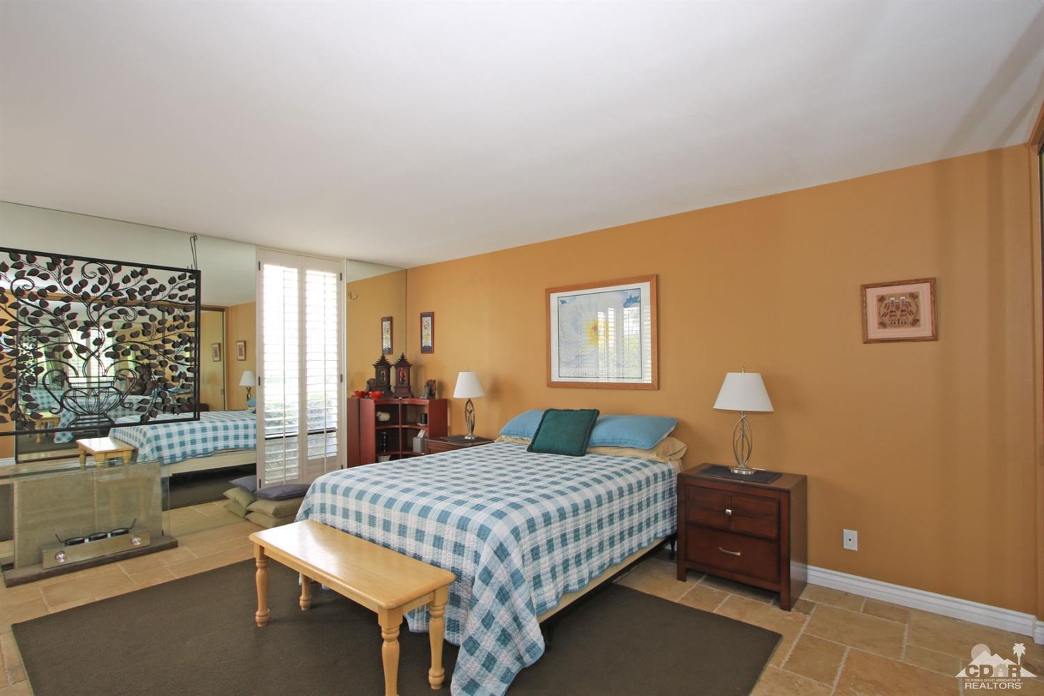 72350 Rodeo Way Rancho Mirage, CA 92270 - Photo 17 of 44 a bedroom with a bed and wooden floor