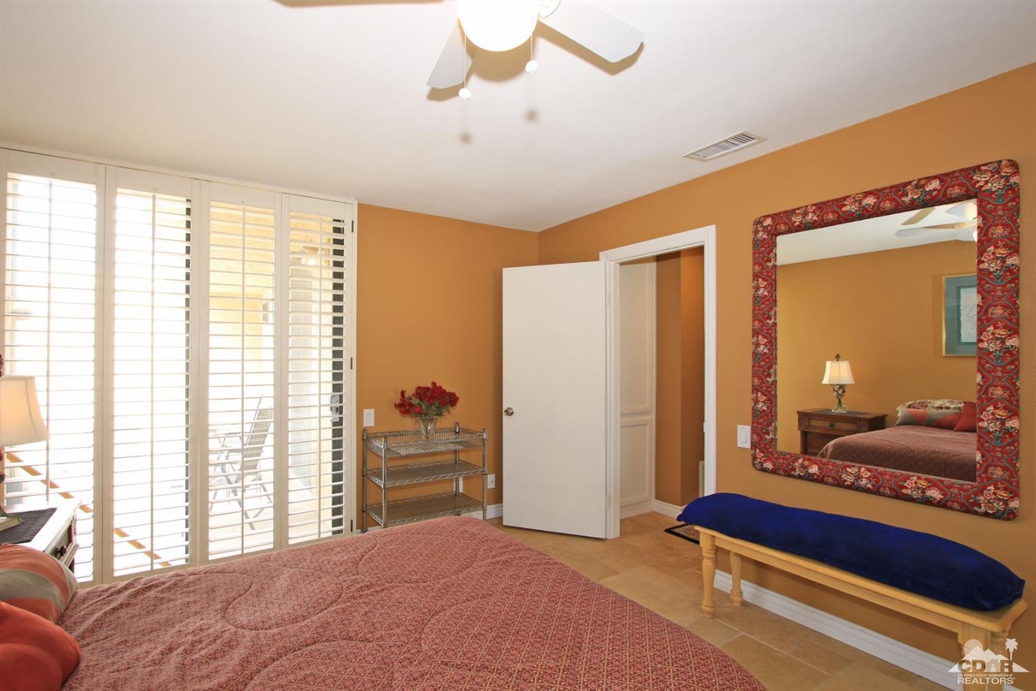 72350 Rodeo Way Rancho Mirage, CA 92270 - Photo 23 of 44 a bedroom with a bed and large windows