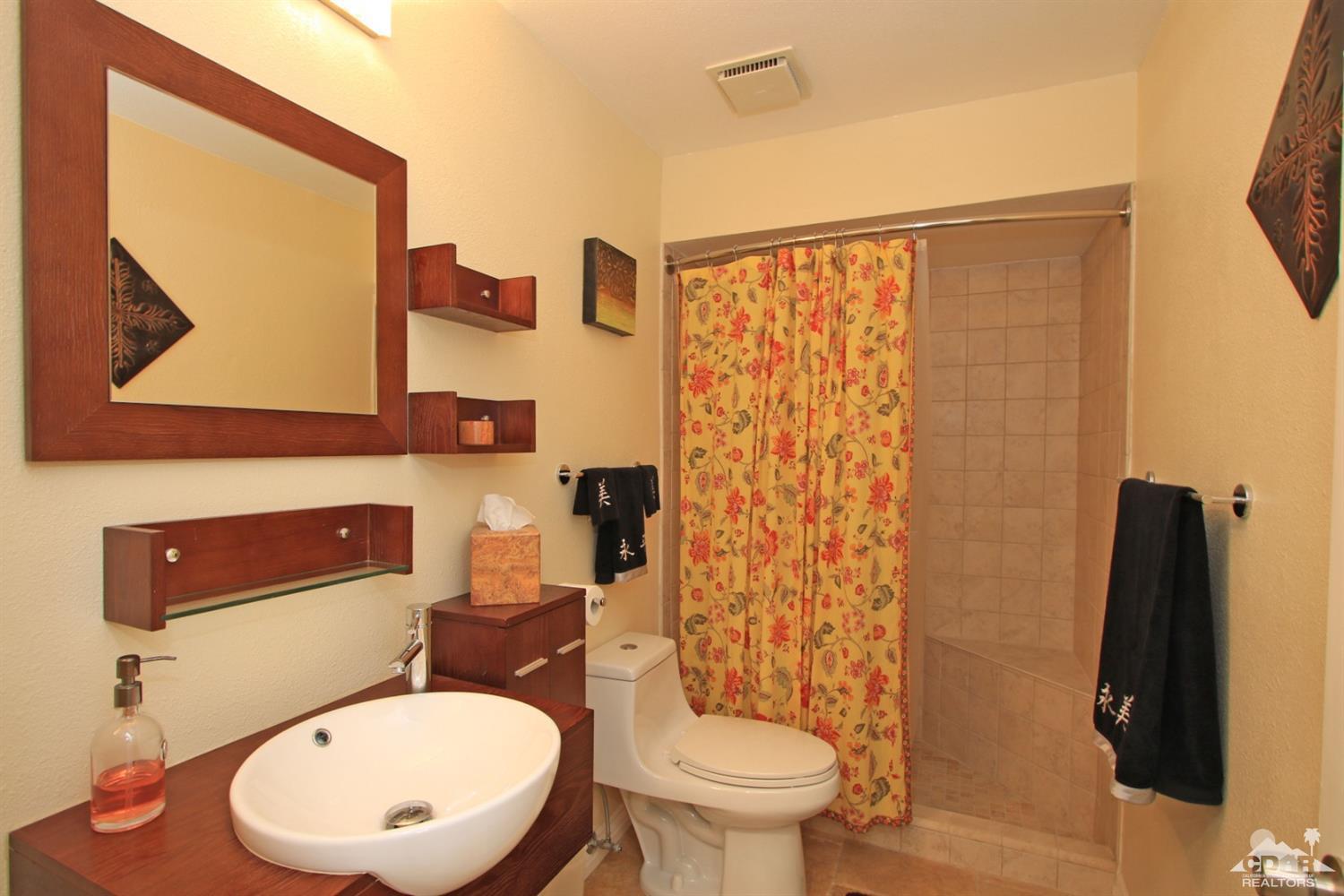 72350 Rodeo Way Rancho Mirage, CA 92270 - Photo 24 of 44 a white toilet sitting next to a bathroom sink