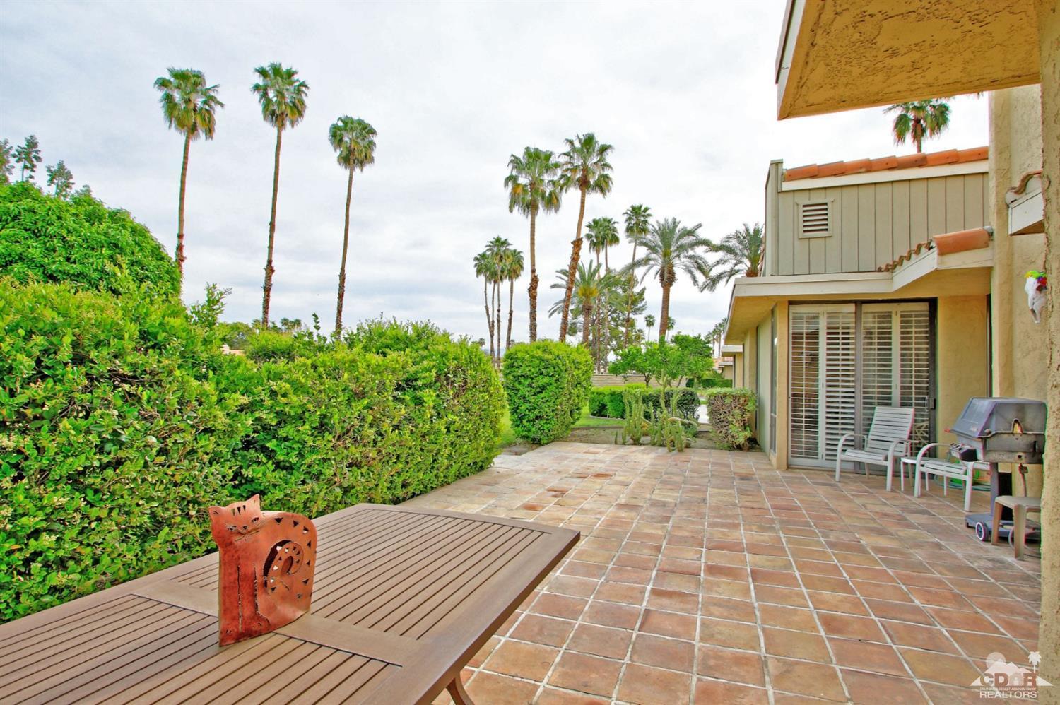 72350 Rodeo Way Rancho Mirage, CA 92270 - Photo 25 of 44 a view of a patio with a table and chairs and potted plants