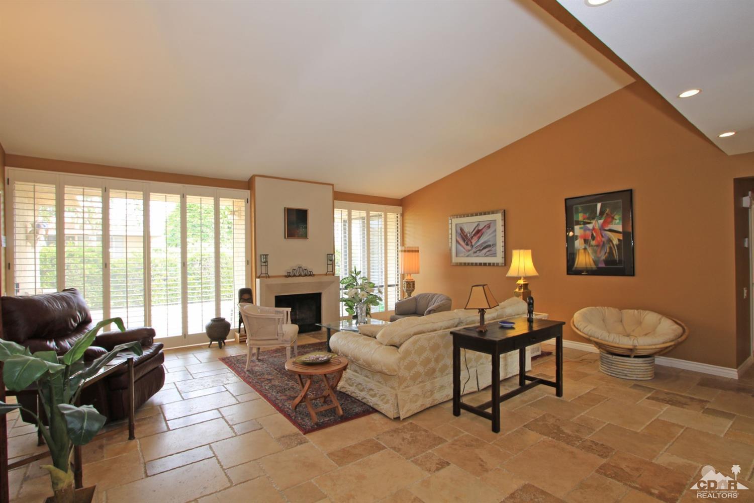 72350 Rodeo Way Rancho Mirage, CA 92270 - Photo 7 of 44 a living room with furniture a fireplace and a large window