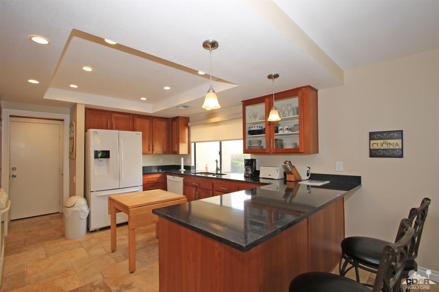 72350 Rodeo Way Rancho Mirage, CA 92270 - Photo 8 of 44 a kitchen with granite countertop a sink and refrigerator