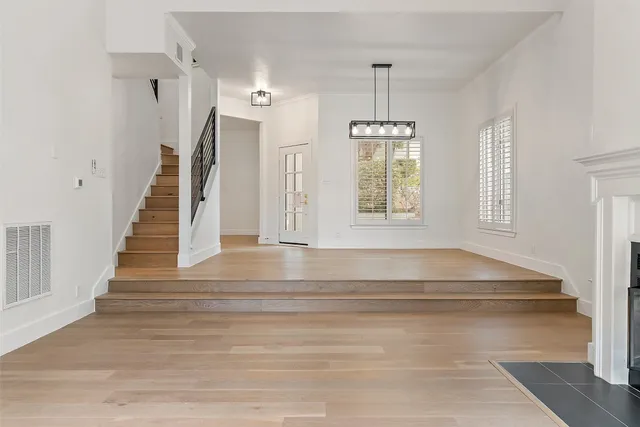 a view of staircase with white walls and windows