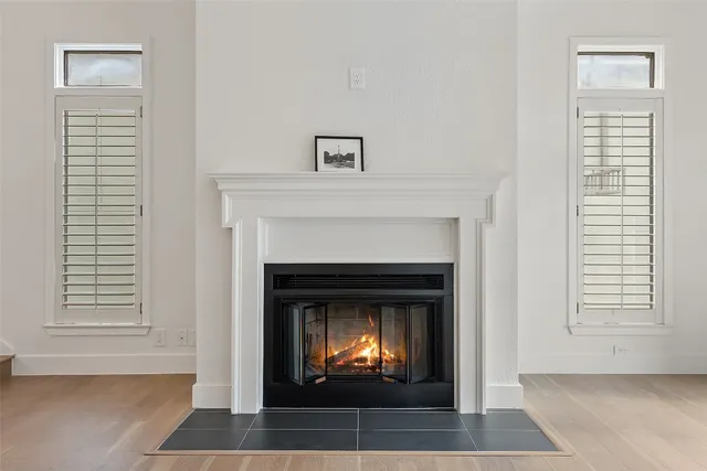 a living room with a fireplace and a window
