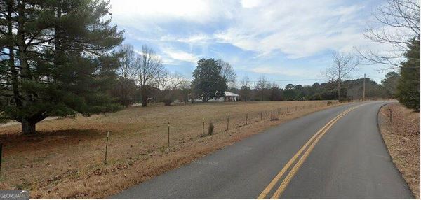 a view of a road with a yard