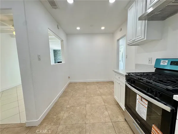 a kitchen with white cabinets stainless steel appliances and sink