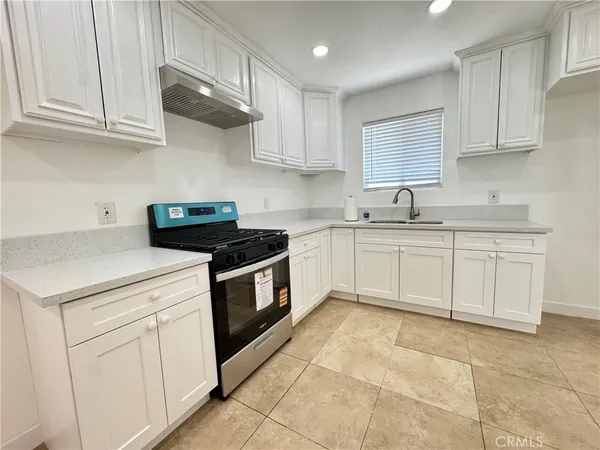 a bathroom with a granite countertop sink a toilet and a mirror