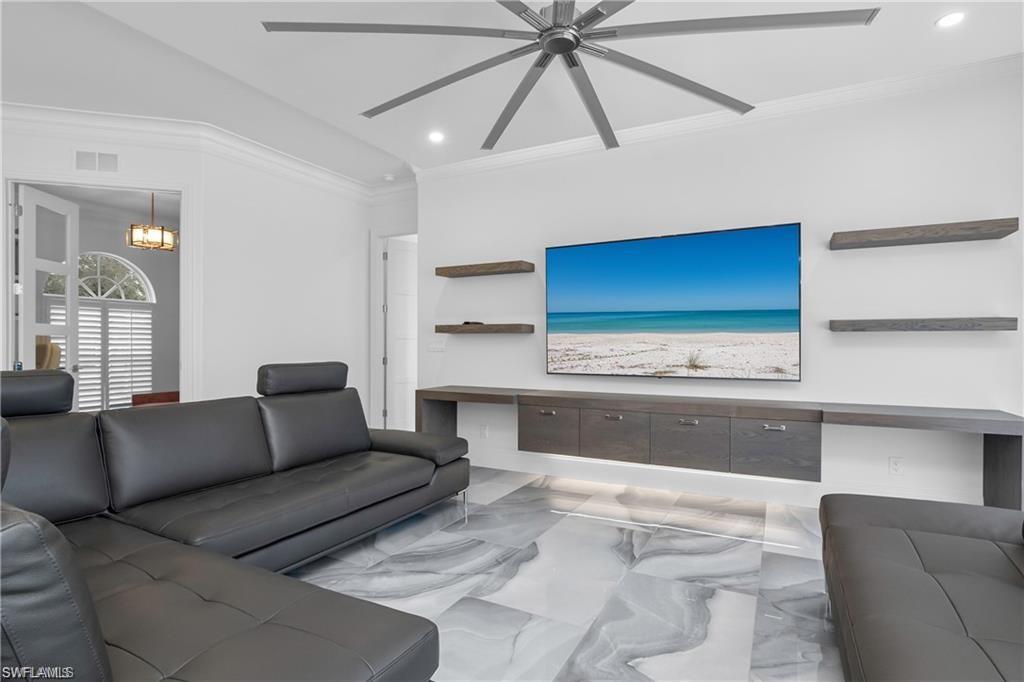8967 Lely Island Circle Naples, FL 34113 - Photo 12 of 46 a living room with furniture and a large window