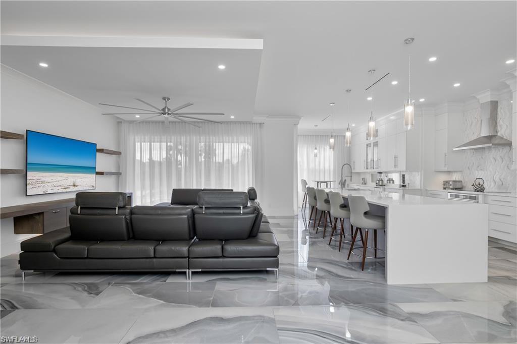 8967 Lely Island Circle Naples, FL 34113 - Photo 14 of 46 a living room with furniture and a view of kitchen