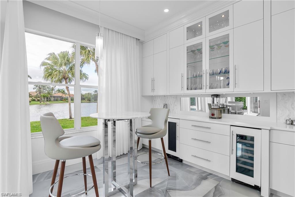 8967 Lely Island Circle Naples, FL 34113 - Photo 23 of 46 a kitchen with a table chairs and a window