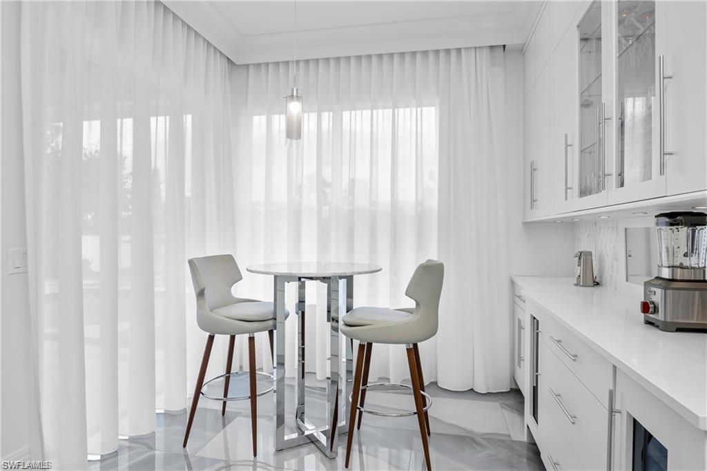 8967 Lely Island Circle Naples, FL 34113 - Photo 24 of 46 a view of a dining room with furniture and a window