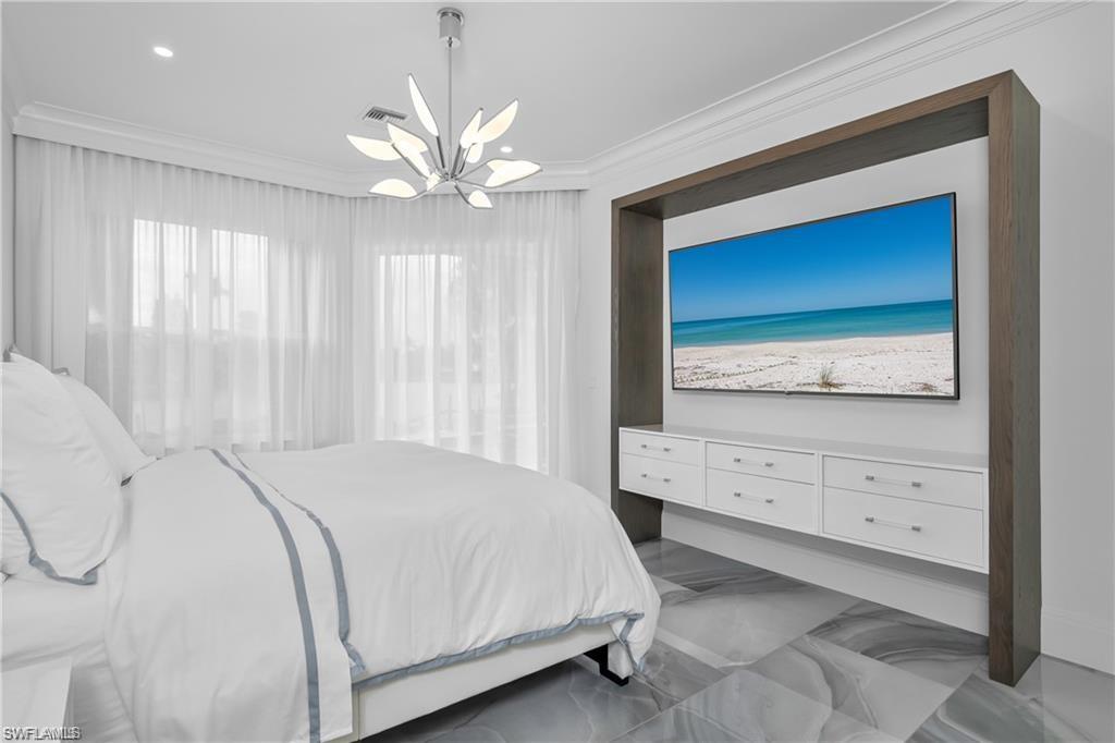 8967 Lely Island Circle Naples, FL 34113 - Photo 28 of 46 a bedroom with a bed and a dresser