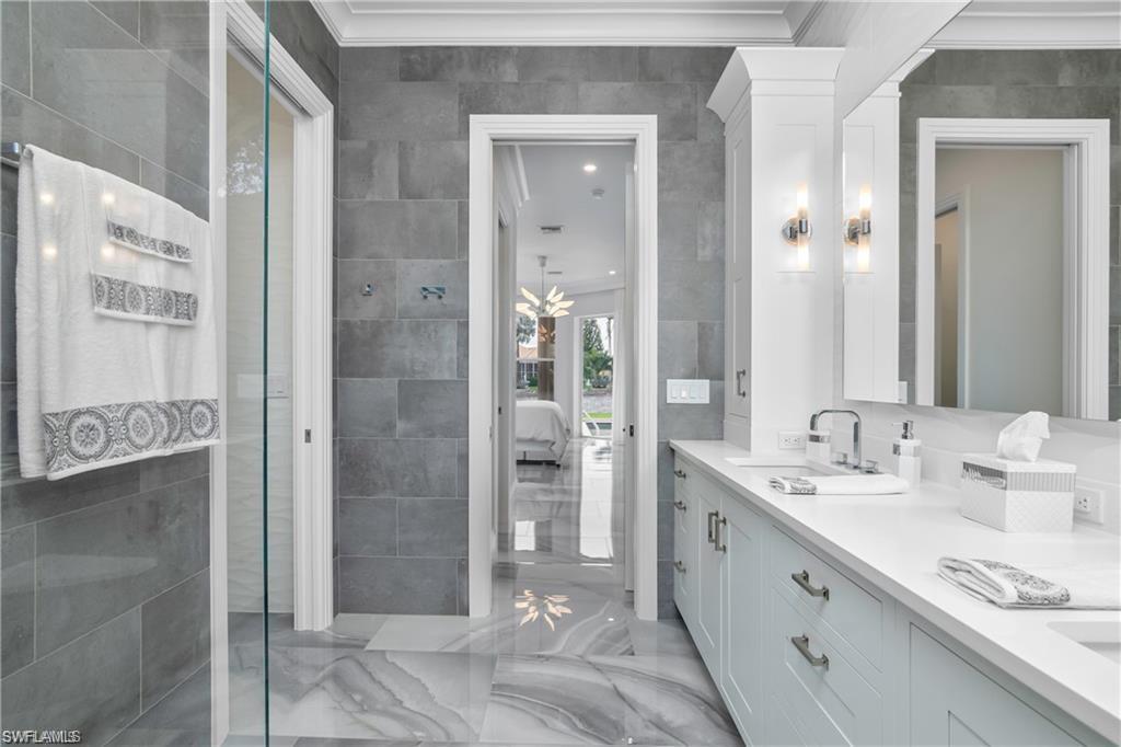 8967 Lely Island Circle Naples, FL 34113 - Photo 33 of 46 a spacious bathroom with a shower and a sink