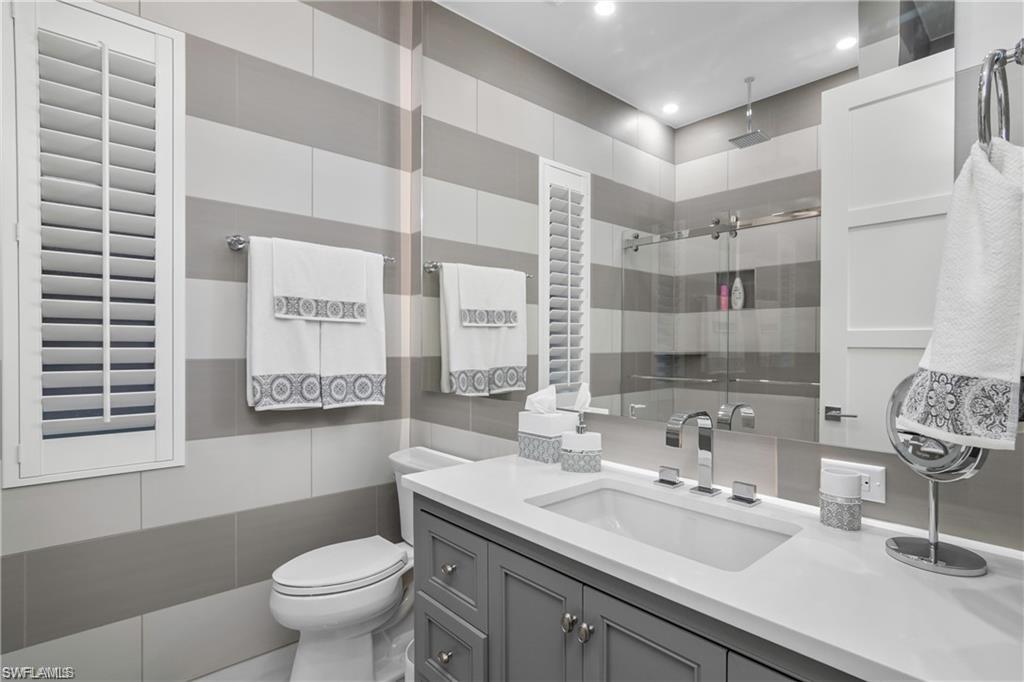 8967 Lely Island Circle Naples, FL 34113 - Photo 37 of 46 a bathroom with a sink toilet and shower