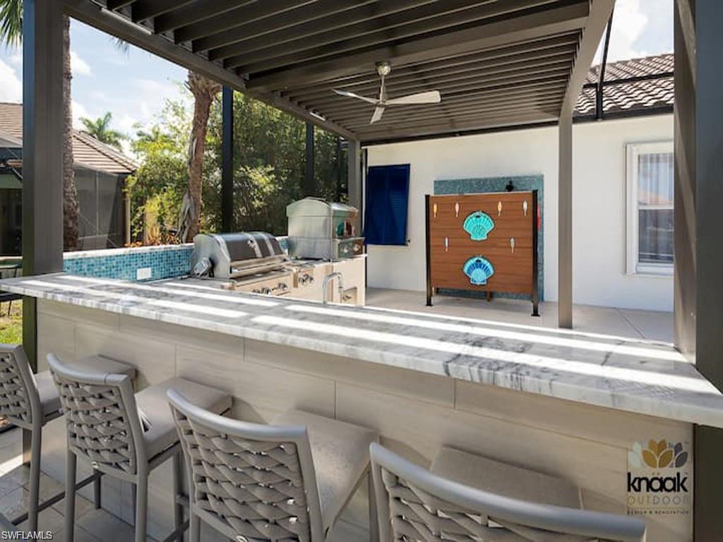 8967 Lely Island Circle Naples, FL 34113 - Photo 4 of 46 a kitchen with a table and chairs