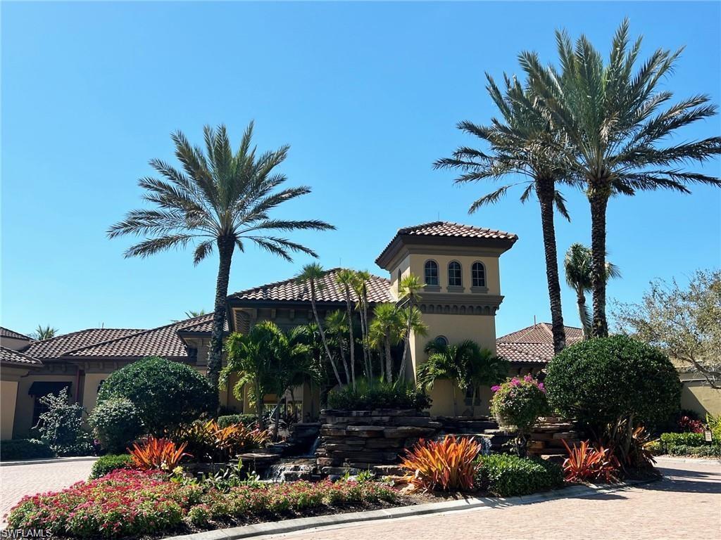 8967 Lely Island Circle Naples, FL 34113 - Photo 45 of 46 a front view of a house with a yard and palm trees